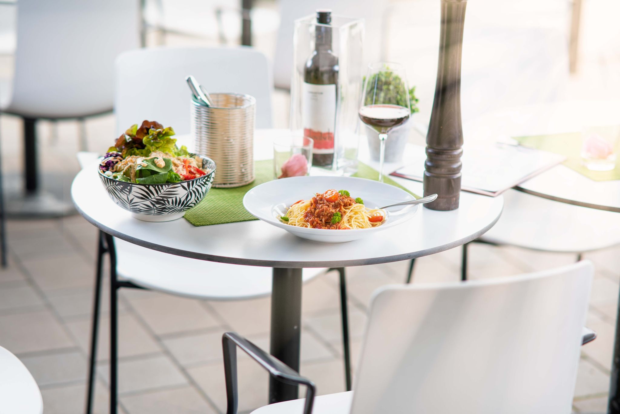 Liebevoll gedeckter Tisch mit Pasta, Salat und Wein im FantasTisch