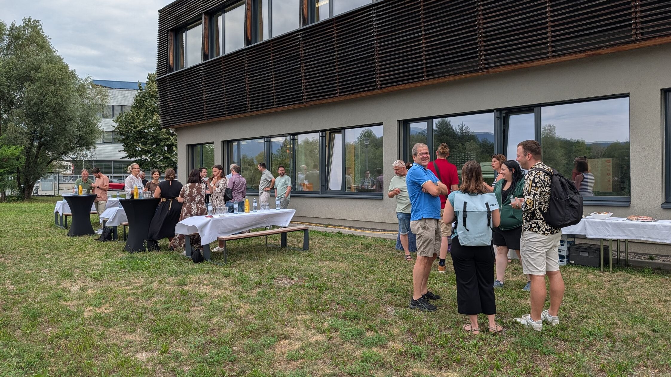 Relaxed networking and conversations outdoors at the fourth Business Breakfast Participants at the Business Breakfast chat with one another.
